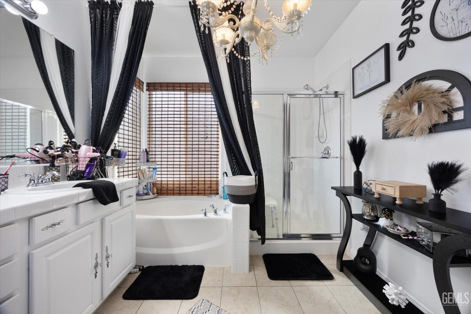 Undisclosed Address Bakersfield, CA 93312 - Photo 27 of 47 a bathroom with a sink a mirror a vanity and window