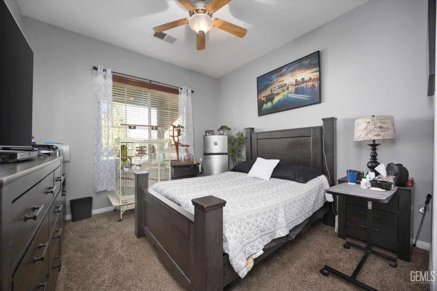 Undisclosed Address Bakersfield, CA 93312 - Photo 28 of 47 a bedroom with a bed and a chandelier