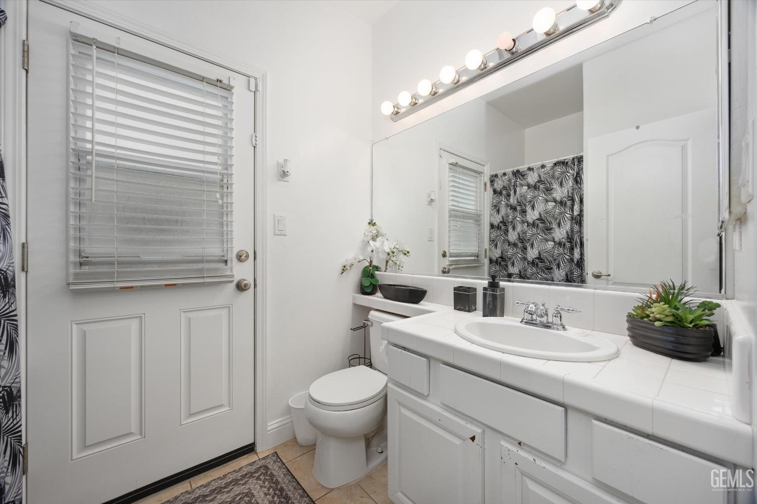 Undisclosed Address Bakersfield, CA 93312 - Photo 29 of 47 a bathroom with a sink a toilet and vanity