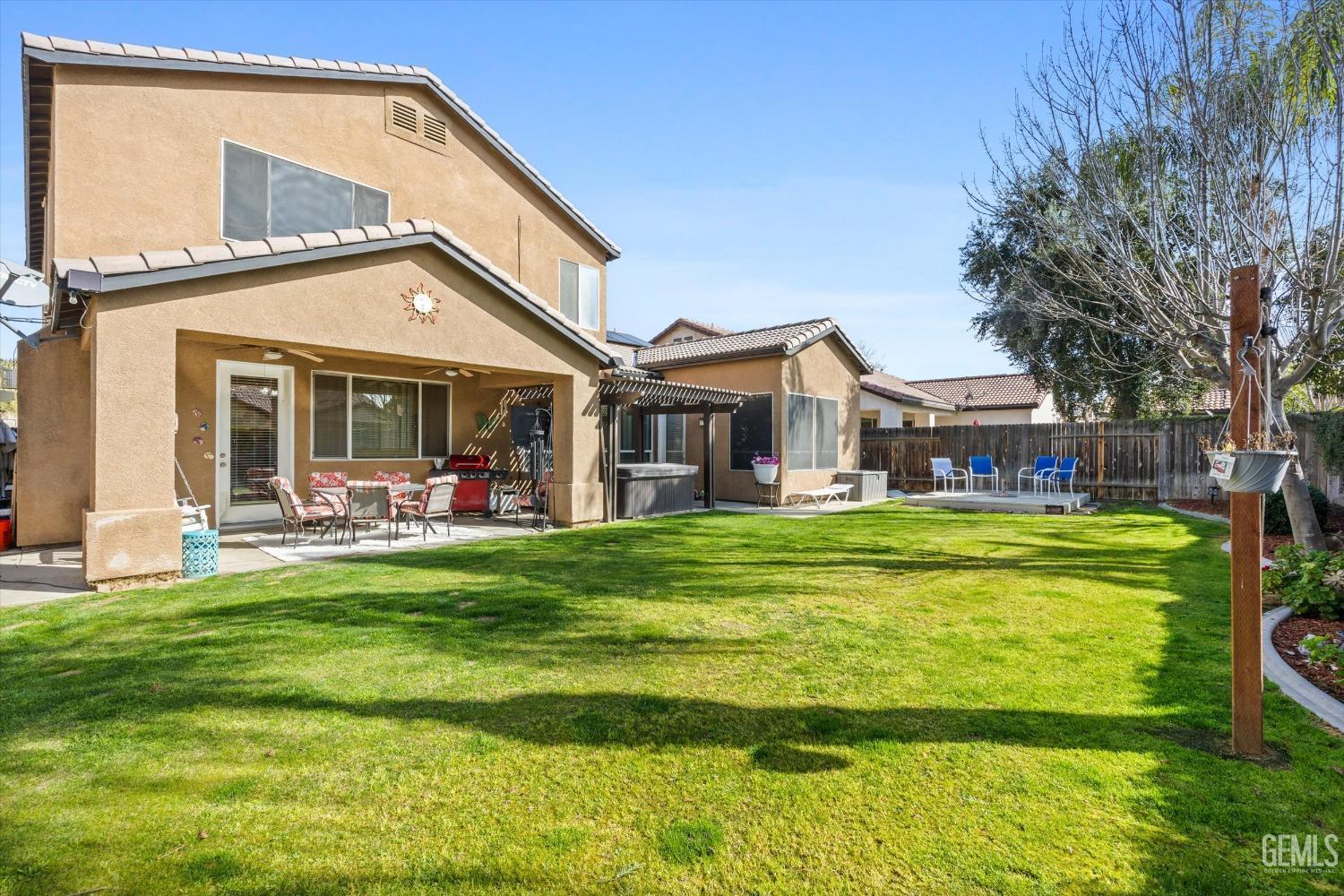 Undisclosed Address Bakersfield, CA 93312 - Photo 38 of 47 a front view of a house with a garden and swimming pool