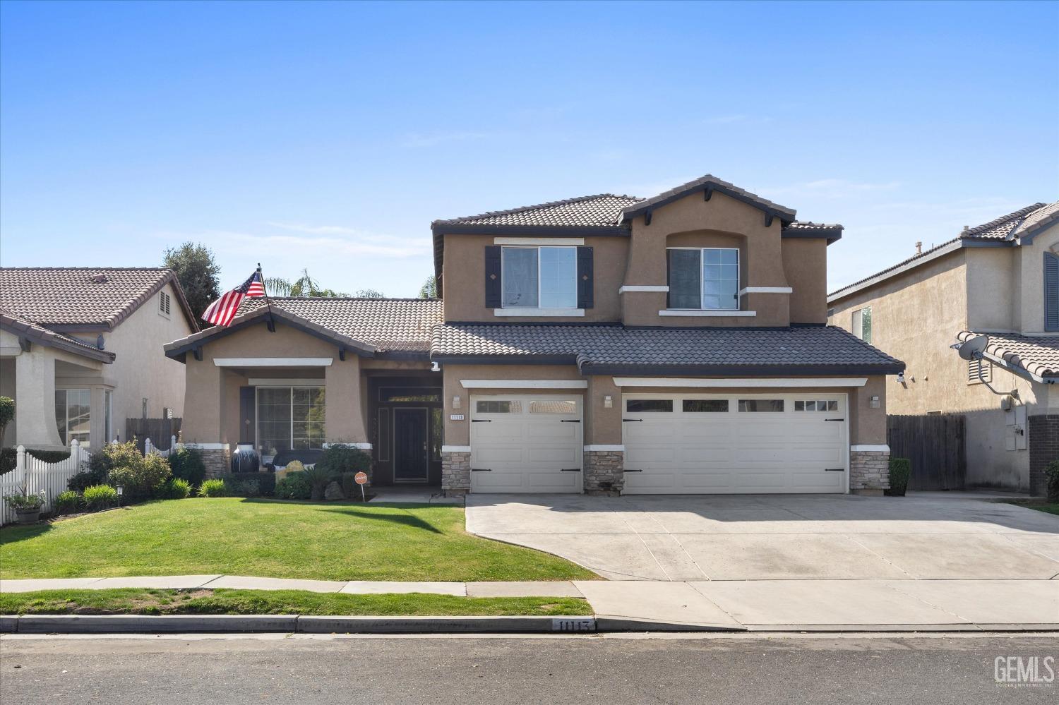 Undisclosed Address Bakersfield, CA 93312 - Photo 47 of 47 a front view of a house with a yard and garage