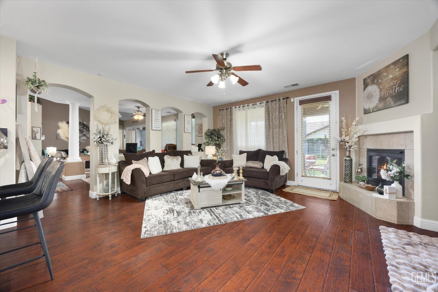 Undisclosed Address Bakersfield, CA 93312 - Photo 7 of 47 a living room with fireplace furniture and a wooden floor