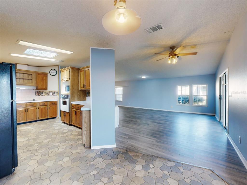 705 Starboard Avenue Edgewater, FL 32141 - Photo 11 of 52 a view of a kitchen center island and living room