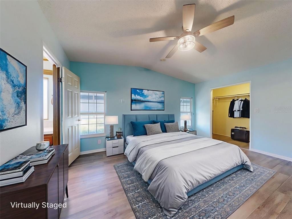 705 Starboard Avenue Edgewater, FL 32141 - Photo 18 of 52 a bedroom with a bed and a chandelier