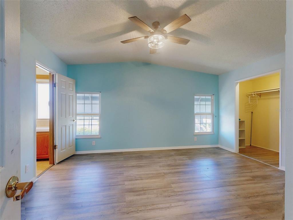705 Starboard Avenue Edgewater, FL 32141 - Photo 19 of 52 an empty room with wooden floor and windows