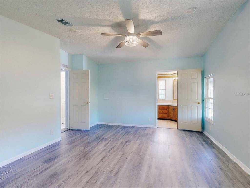 705 Starboard Avenue Edgewater, FL 32141 - Photo 21 of 52 a view of an empty room with wooden floor and window