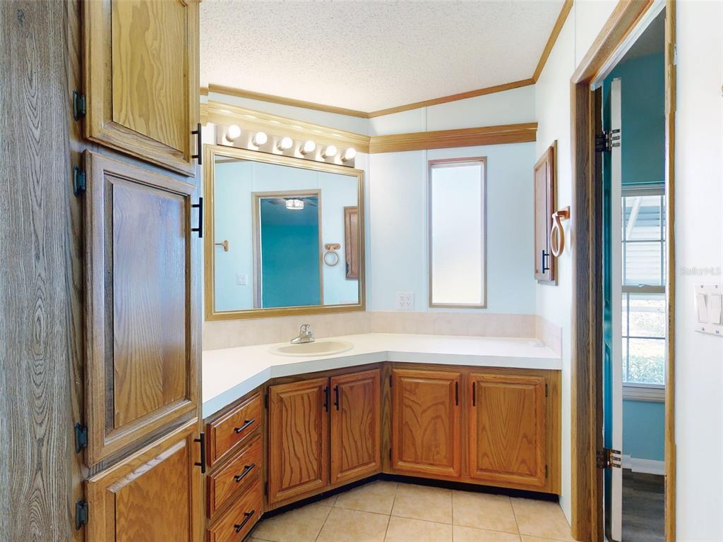 705 Starboard Avenue Edgewater, FL 32141 - Photo 24 of 52 a bathroom with a sink a mirror and a shower