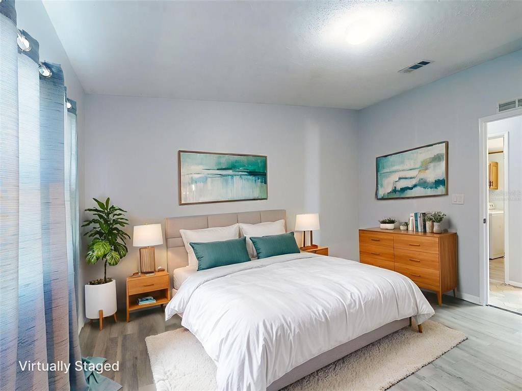 705 Starboard Avenue Edgewater, FL 32141 - Photo 25 of 52 a spacious bedroom with a bed and a couch