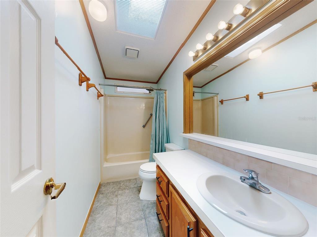 705 Starboard Avenue Edgewater, FL 32141 - Photo 29 of 52 a bathroom with a sink and mirror