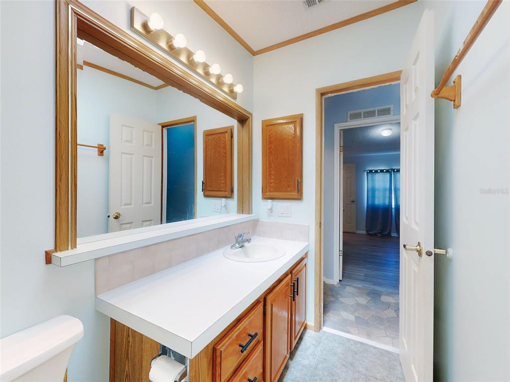 705 Starboard Avenue Edgewater, FL 32141 - Photo 30 of 52 a bathroom with a sink a toilet and a mirror