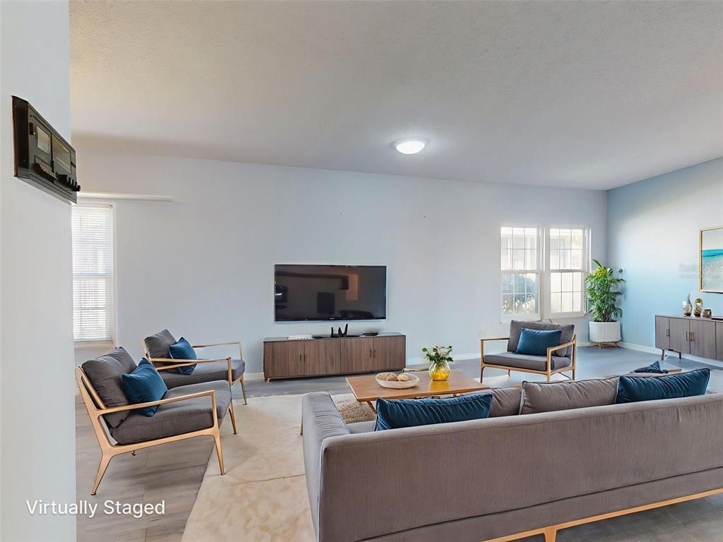 705 Starboard Avenue Edgewater, FL 32141 - Photo 3 of 52 a living room with furniture and a flat screen tv