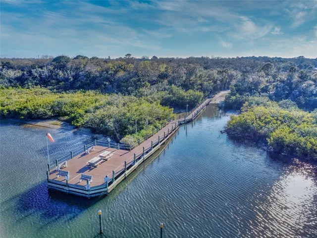 an aerial view of a house with garden space and lake view