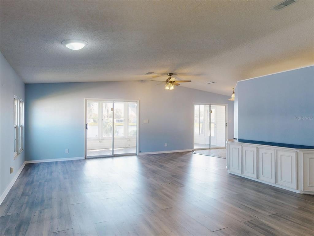 705 Starboard Avenue Edgewater, FL 32141 - Photo 5 of 52 a view of an empty room with wooden floor and a window