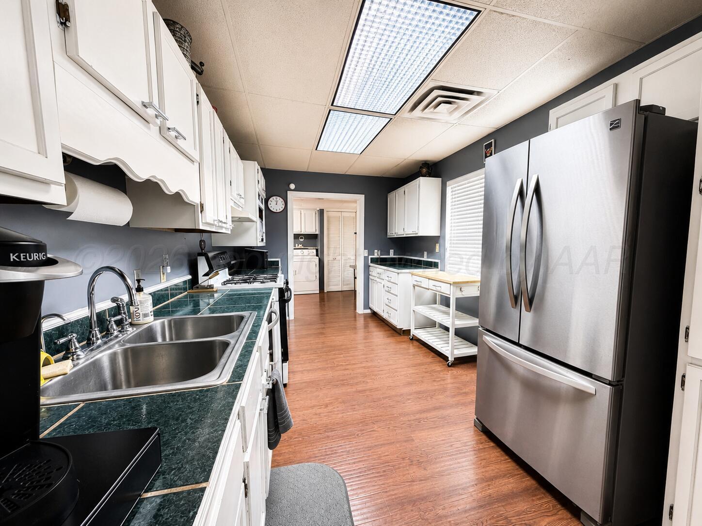 606 South Prospect Street Amarillo, TX 79106 - Photo 6 of 22 a kitchen with stainless steel appliances granite countertop a refrigerator a sink and a stove