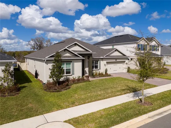 a front view of a house with a garden and plants