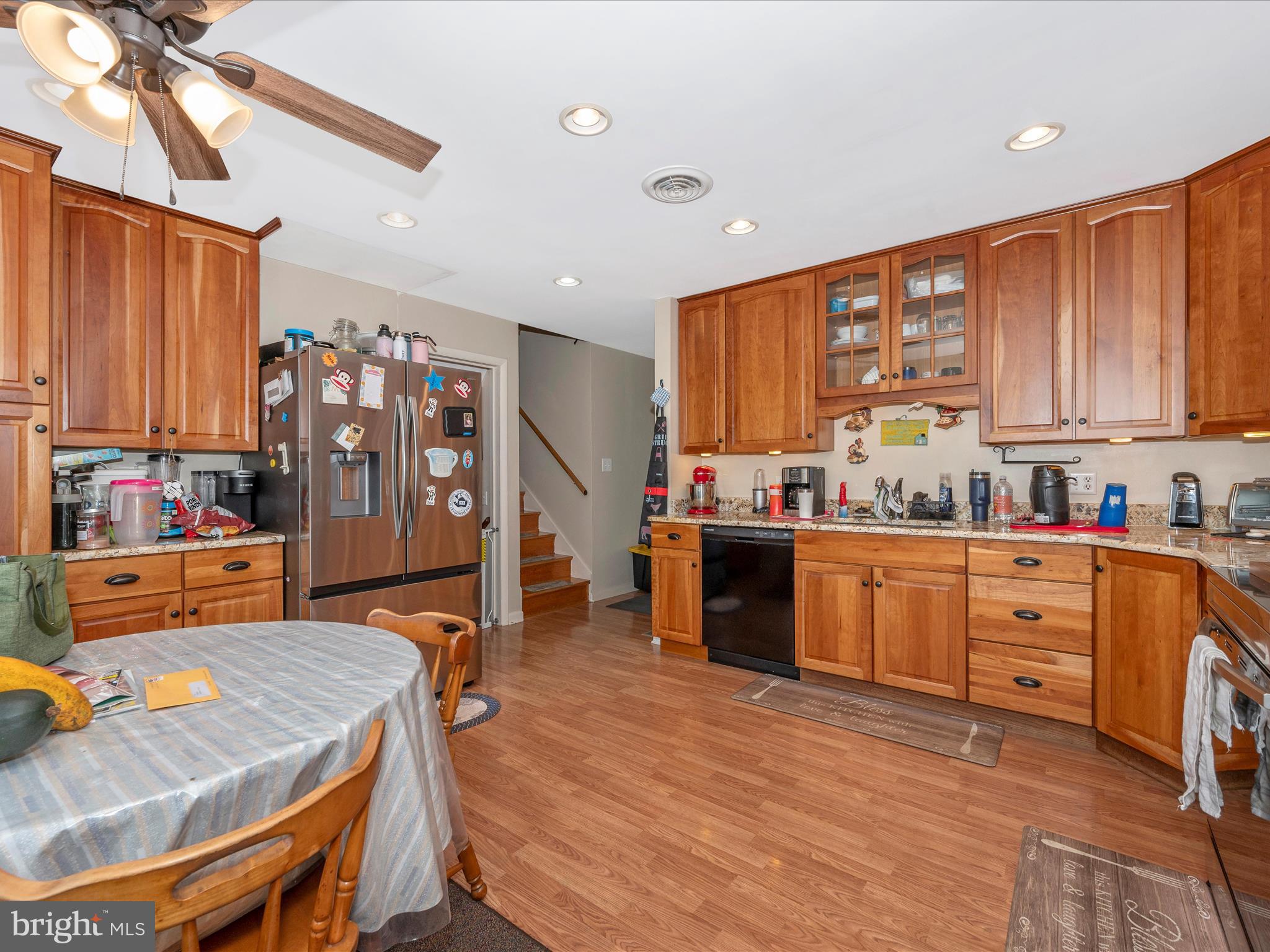 6423 Bikle Road Fayetteville, PA 17222 - Photo 11 of 56 a kitchen with stainless steel appliances kitchen island granite countertop a table chairs in it and wooden floors