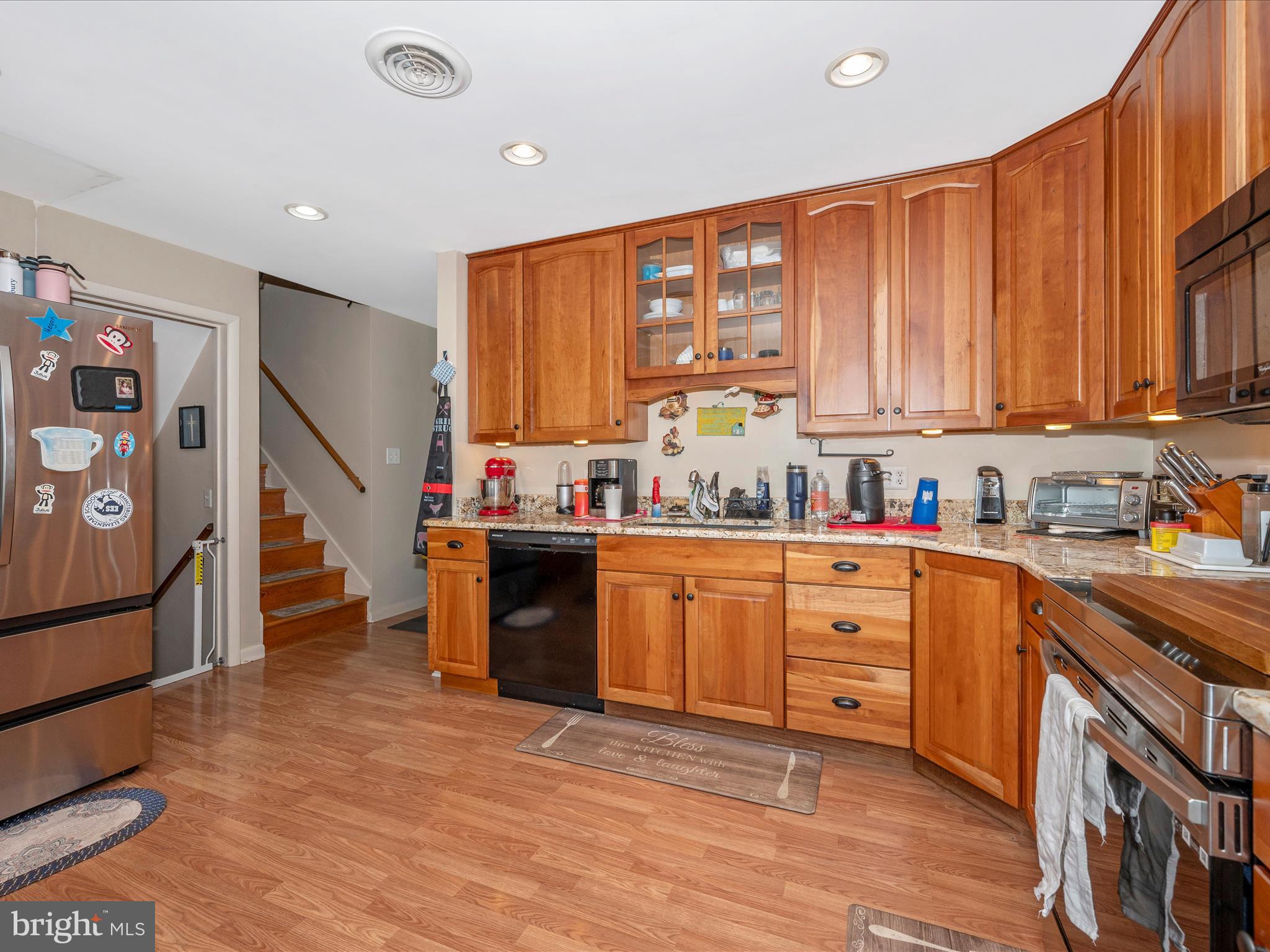 6423 Bikle Road Fayetteville, PA 17222 - Photo 12 of 56 a kitchen with stainless steel appliances granite countertop a refrigerator a sink dishwasher a stove and white countertops with wooden floor