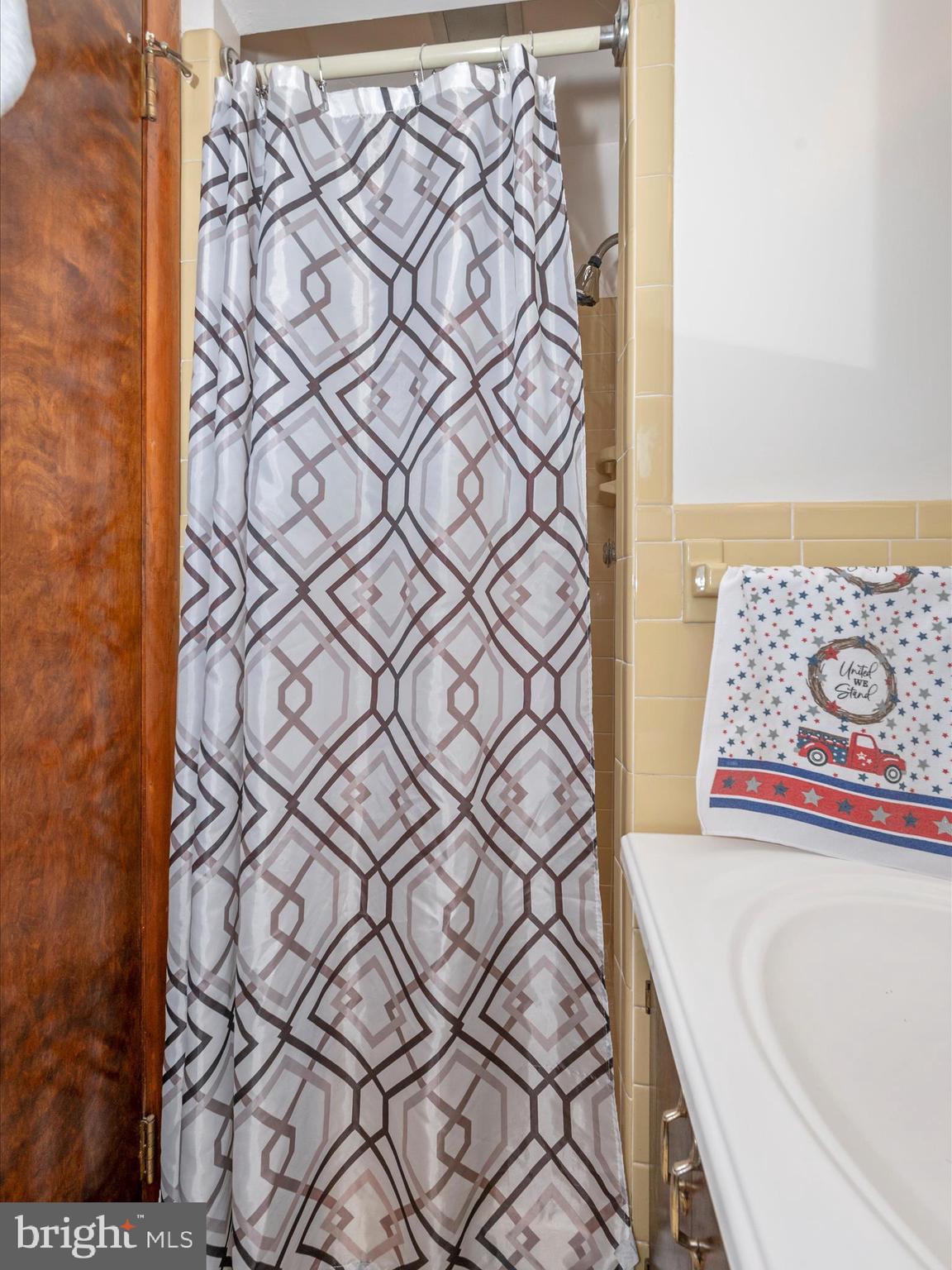 6423 Bikle Road Fayetteville, PA 17222 - Photo 34 of 56 a bathroom with a bathtub and shower curtain