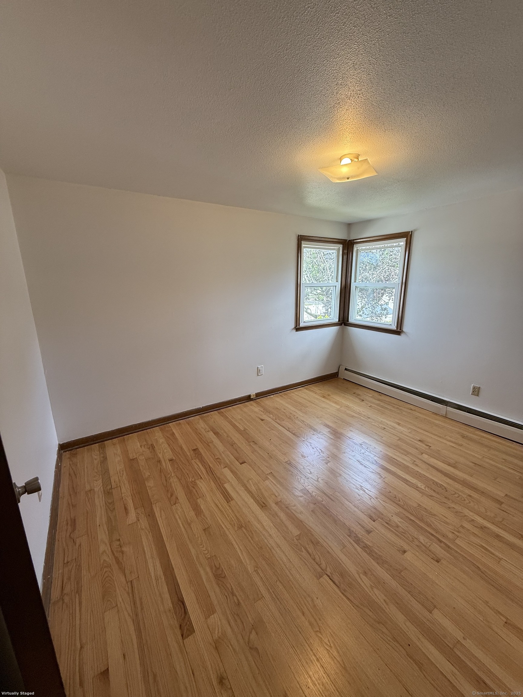 147 Overlook Avenue New Britain, CT 06053 - Photo 3 of 8 an empty room with wooden floor and windows