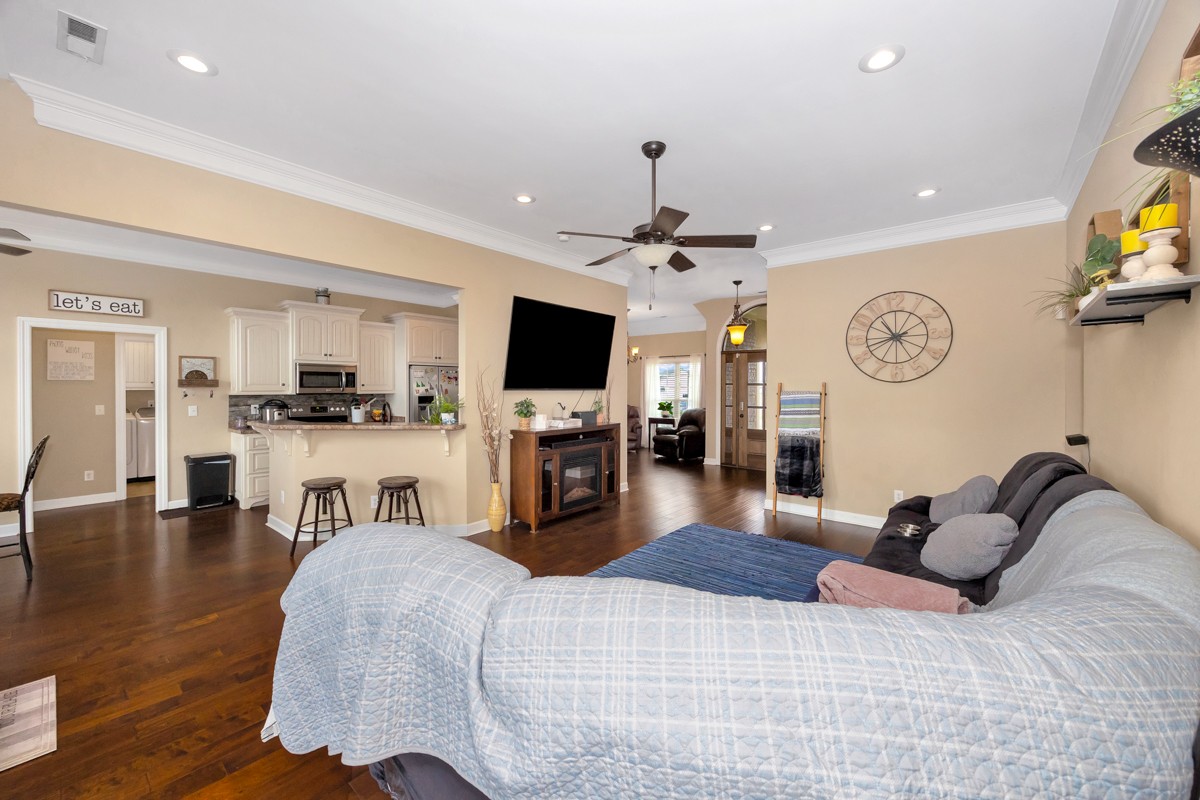402 Vista Shores Road Rogersville, AL 35652 - Photo 13 of 55 a living room with furniture a flat screen tv and kitchen view