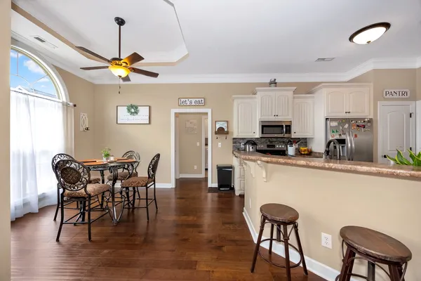 a view of a dining room with furniture window and wooden floor