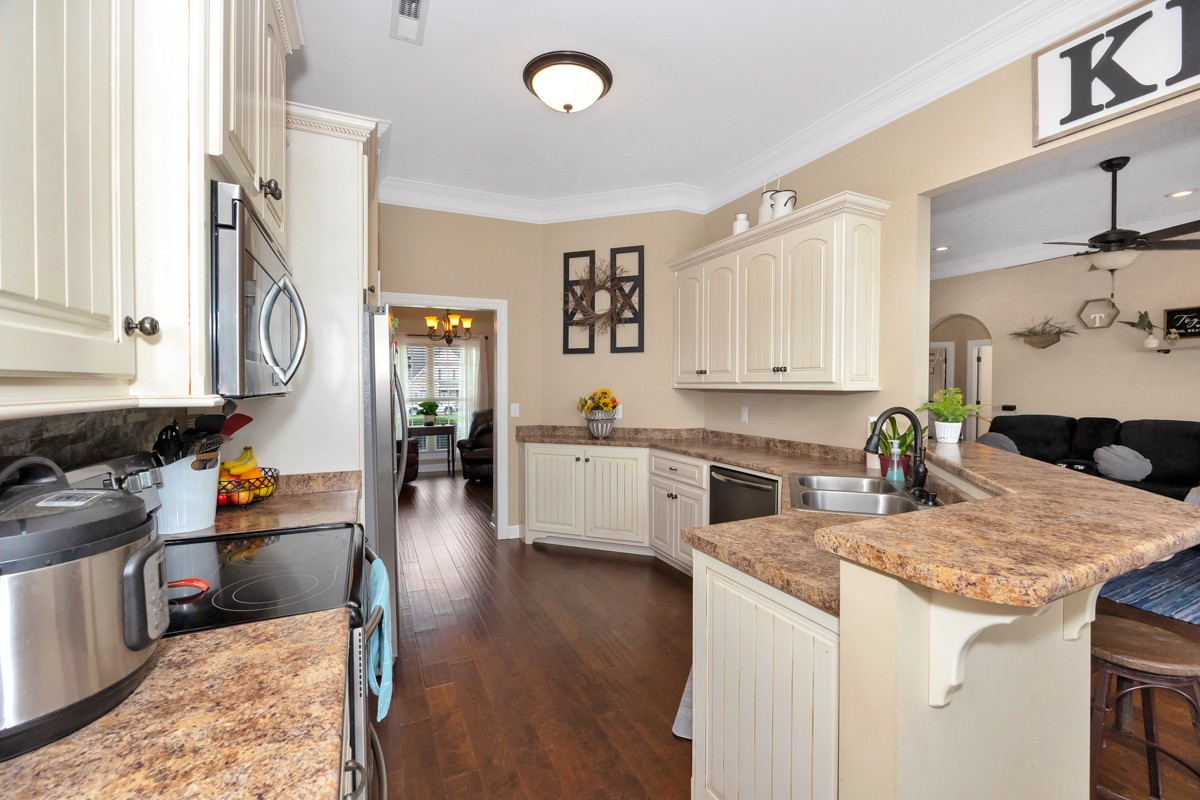 402 Vista Shores Road Rogersville, AL 35652 - Photo 17 of 55 a kitchen with a stove and white cabinets