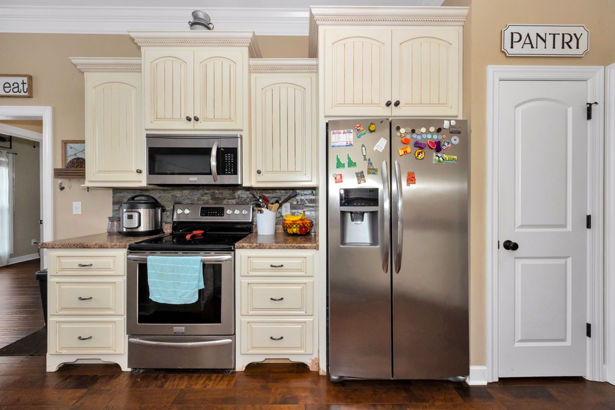 402 Vista Shores Road Rogersville, AL 35652 - Photo 19 of 55 a kitchen with white cabinets and stainless steel appliances