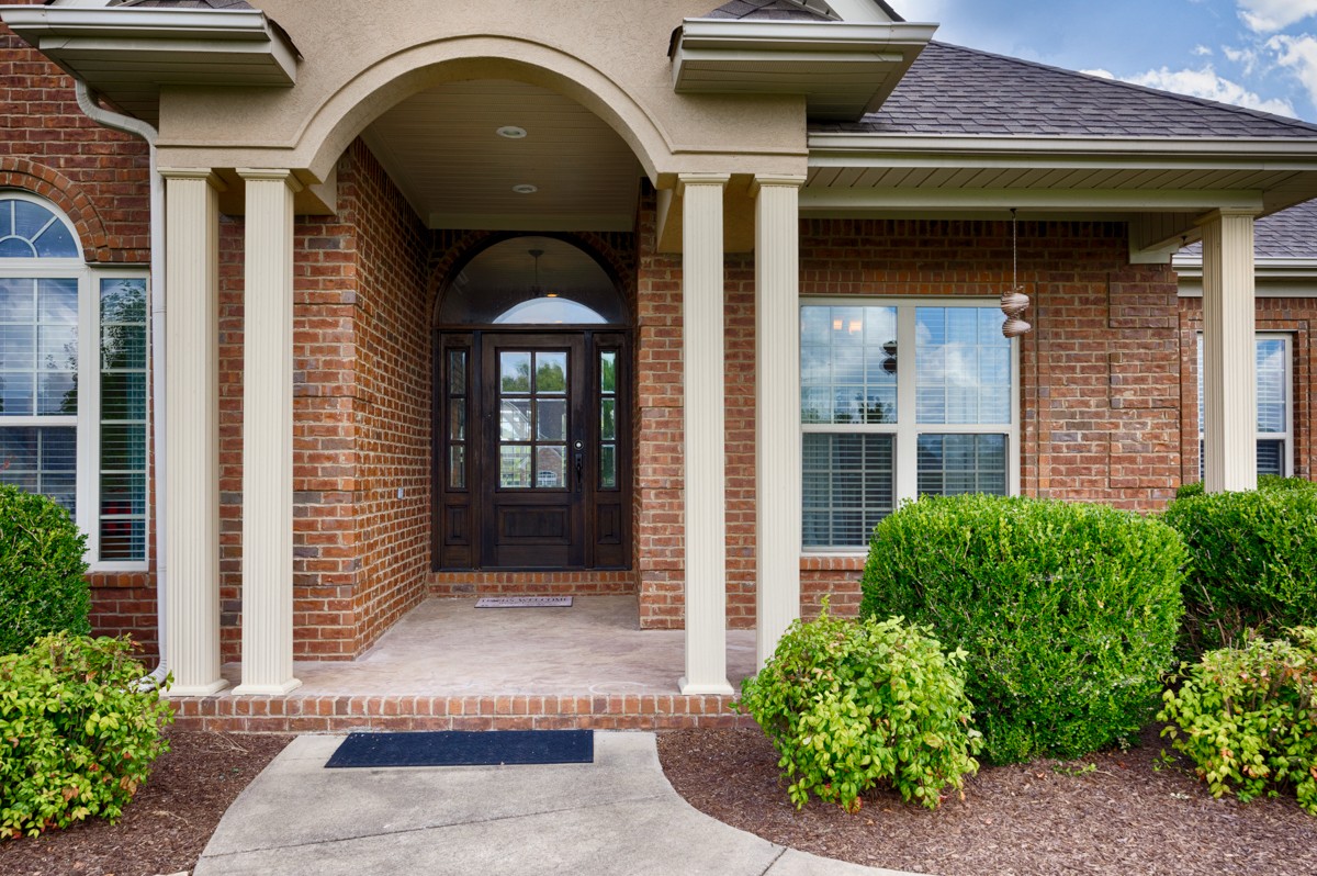 402 Vista Shores Road Rogersville, AL 35652 - Photo 2 of 55 a view of a brick house with potted plants