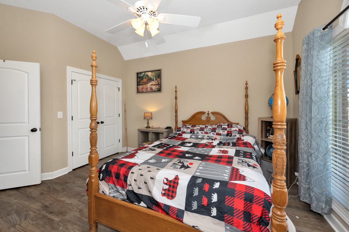 402 Vista Shores Road Rogersville, AL 35652 - Photo 23 of 55 a bedroom with a bed and a chandelier