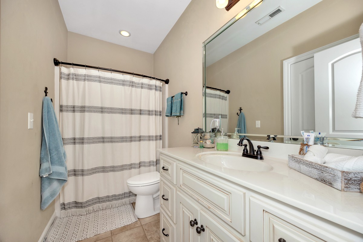 402 Vista Shores Road Rogersville, AL 35652 - Photo 26 of 55 a bathroom with a double vanity sink toilet and shower