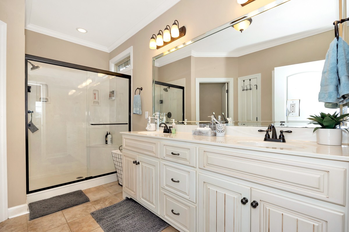 402 Vista Shores Road Rogersville, AL 35652 - Photo 29 of 55 a bathroom with a double vanity sink mirror and shower