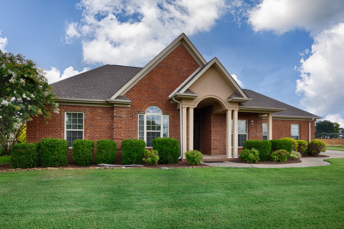 402 Vista Shores Road Rogersville, AL 35652 - Photo 34 of 55 a front view of a house with a garden and plants