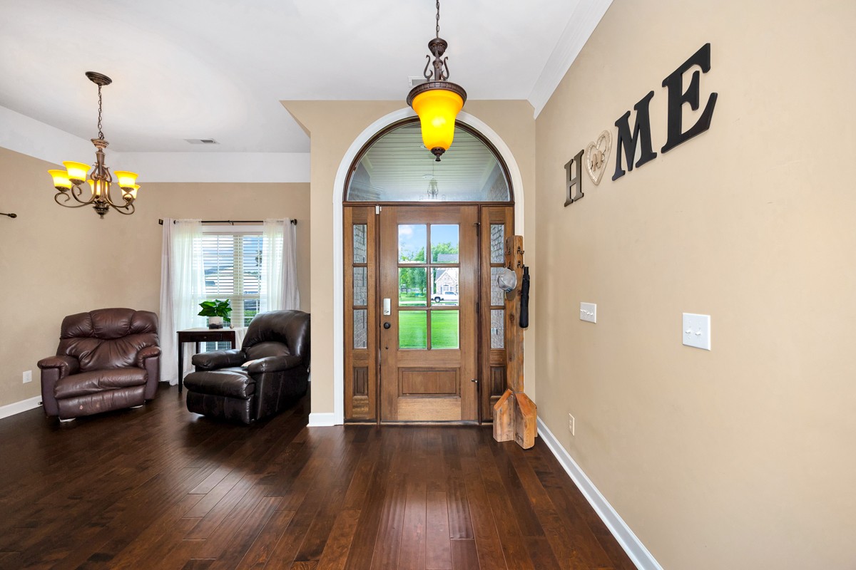 402 Vista Shores Road Rogersville, AL 35652 - Photo 4 of 55 a living room with couches and a chandelier