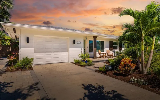 a front view of a house with a yard and a garage
