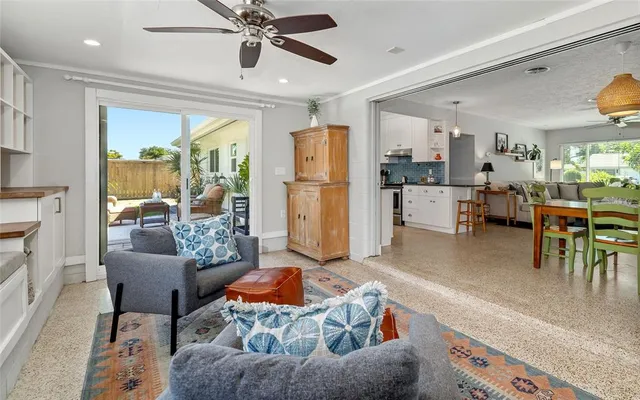 a living room with furniture and a kitchen