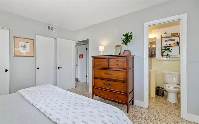 a bedroom with a bed and a dresser