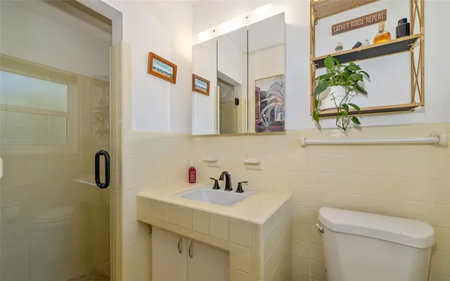 a bathroom with a sink a toilet and a mirror