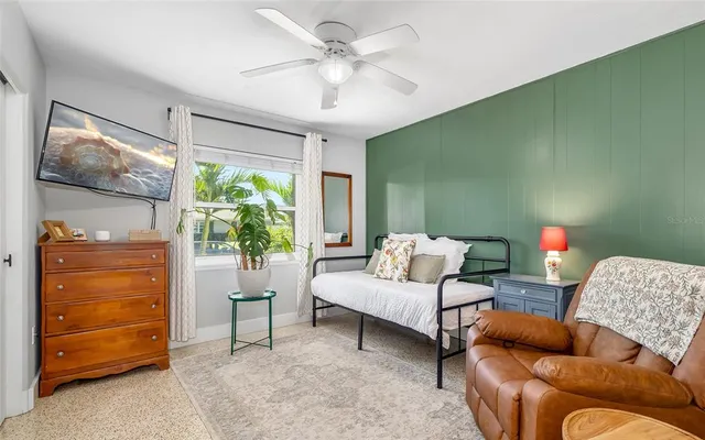 a bedroom with furniture and a window