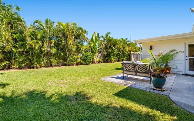 a view of a patio with table and chairs under an umbrella