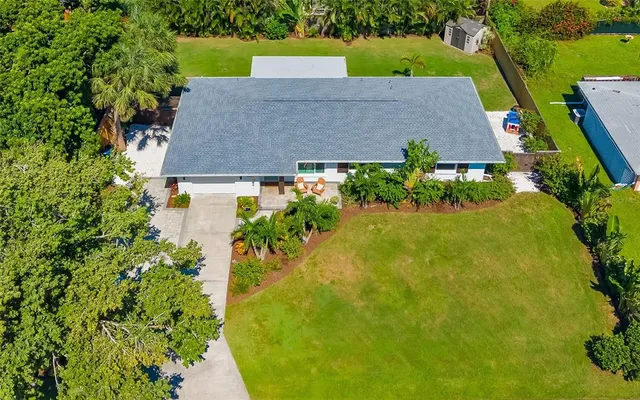an aerial view of a house with a yard basket ball court and outdoor seating
