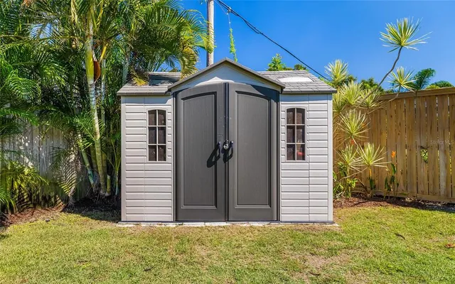 a view of a backyard with plants and a garden