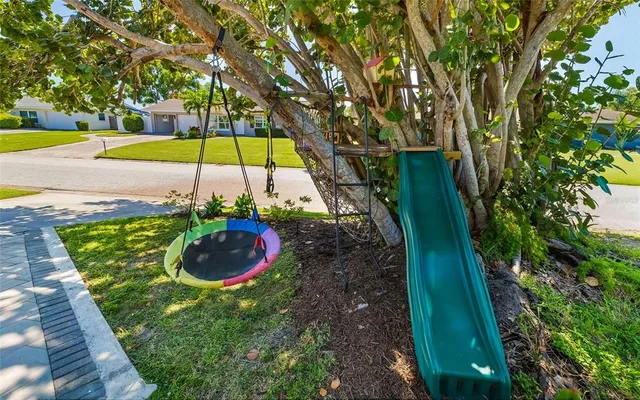 a view of a house with a yard and sitting area