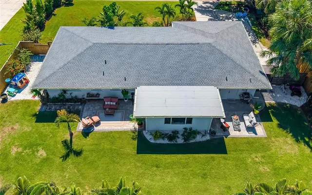 an aerial view of a house with a yard basket ball court and outdoor seating