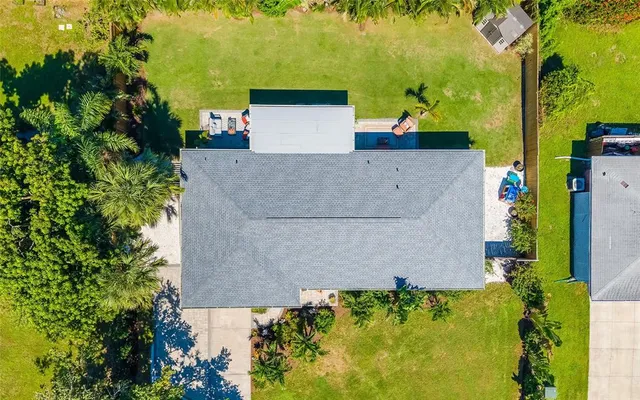 an aerial view of residential houses with outdoor space and parking