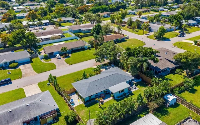 an aerial view of house with a yard