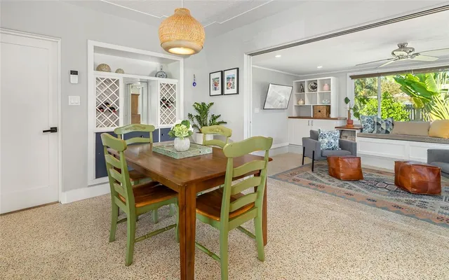 a view of a dining room and livingroom with furniture wooden floor and a rug