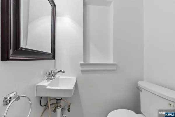 a bathroom with a sink mirror and toilet