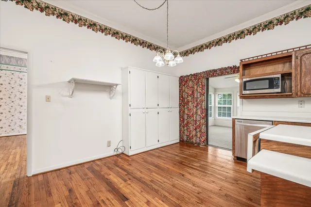 a large white kitchen with a sink stainless steel appliances and cabinets