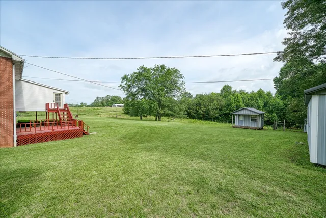 a front view of house with yard and green space