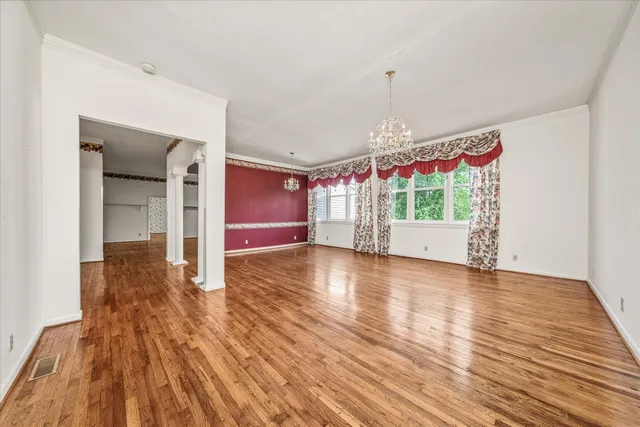 a large white kitchen with a sink and dishwasher a oven with wooden floor